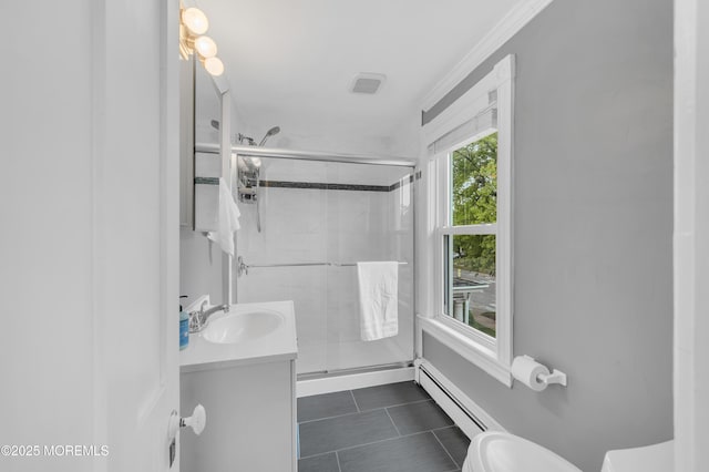 bathroom with a baseboard heating unit, toilet, a stall shower, tile patterned flooring, and crown molding