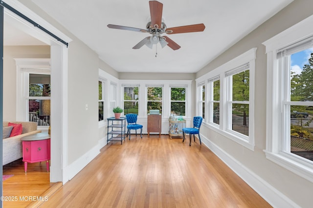 sunroom / solarium with baseboards and hardwood / wood-style floors