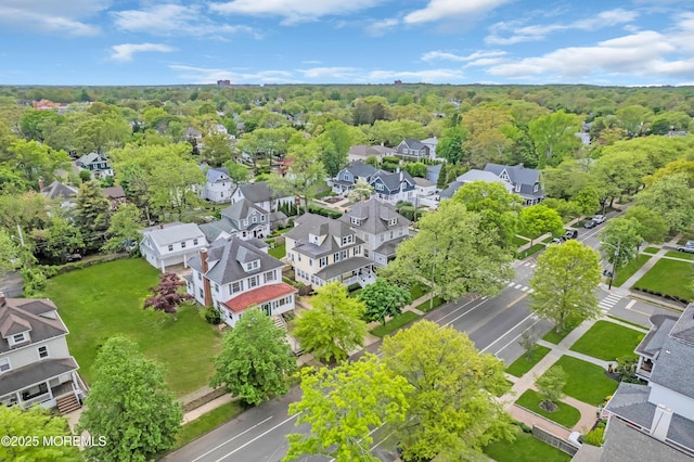 aerial view of residential area featuring a forest