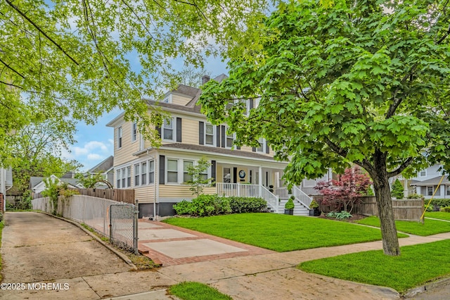 american foursquare style home featuring covered porch, a chimney, and a gate