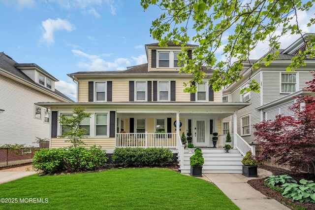 traditional style home with covered porch and a front yard