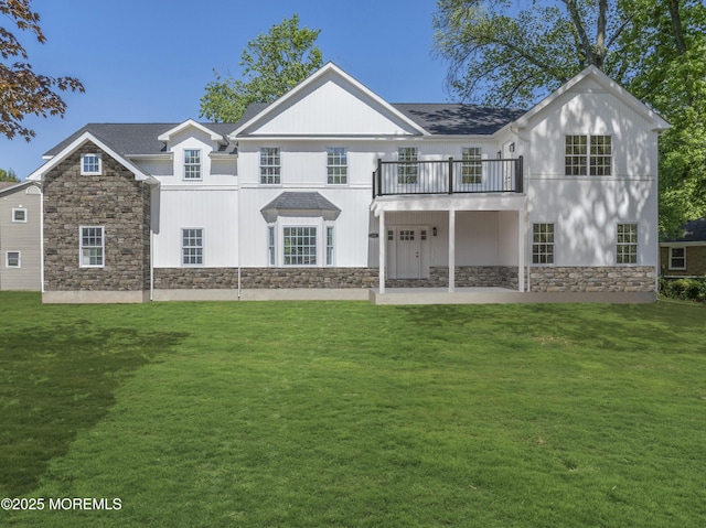 38 Louise Dr, East Brunswick, NJ 08816 - rear view of house featuring stone siding, a balcony, and a yard