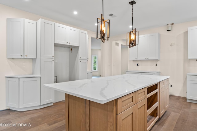 38 Louise Dr, East Brunswick, NJ 08816 - kitchen with wood finished floors, recessed lighting, light stone counters, pendant lighting, and a center island