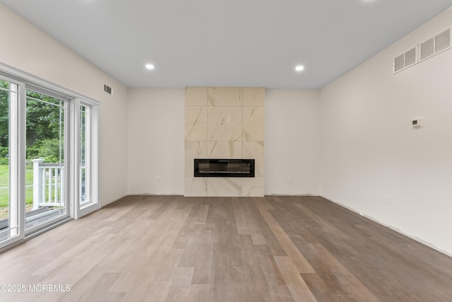 38 Louise Dr, East Brunswick, NJ 08816 - unfurnished living room featuring wood finished floors, a high end fireplace, heating unit, and recessed lighting
