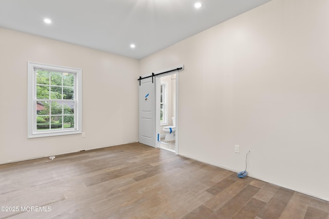 38 Louise Dr, East Brunswick, NJ 08816 - empty room with a barn door, wood finished floors, and recessed lighting