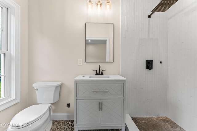 38 Louise Dr, East Brunswick, NJ 08816 - bathroom featuring toilet, vanity, tiled shower, and baseboards