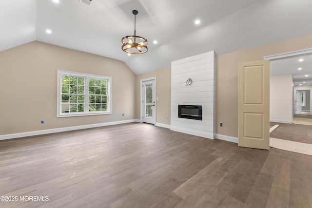 38 Louise Dr, East Brunswick, NJ 08816 - unfurnished living room featuring vaulted ceiling, a chandelier, a fireplace, wood finished floors, and recessed lighting