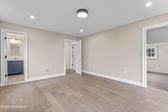 38 Louise Dr, East Brunswick, NJ 08816 - unfurnished bedroom with a sink, light wood-type flooring, baseboards, recessed lighting, and ensuite bath
