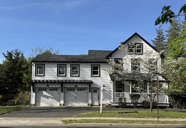 555 Cedar Ave, West Long Branch, NJ 07764 - view of front of home featuring a garage, asphalt driveway, and covered porch