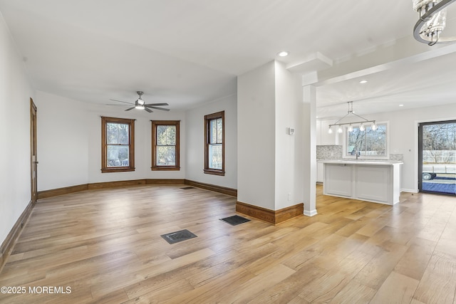 555 Cedar Ave, West Long Branch, NJ 07764 - unfurnished living room with a chandelier, light wood-style floors, recessed lighting, and baseboards
