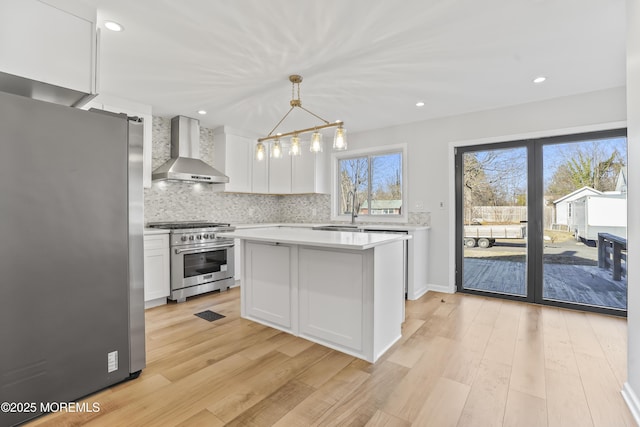 555 Cedar Ave, West Long Branch, NJ 07764 - kitchen featuring wall chimney exhaust hood, stainless steel appliances, light countertops, white cabinetry, and recessed lighting