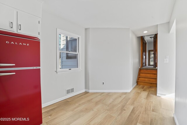 555 Cedar Ave, West Long Branch, NJ 07764 - empty room with light wood-type flooring, plenty of natural light, stairs, and baseboards