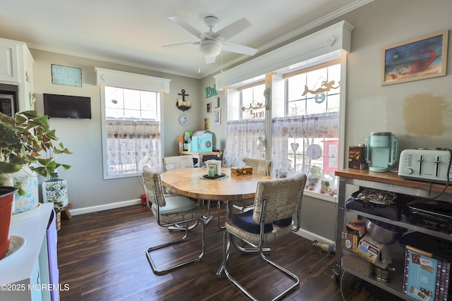 dining room with ornamental molding, wood finished floors, ceiling fan, and baseboards