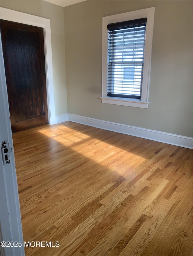 empty room with wood finished floors and baseboards