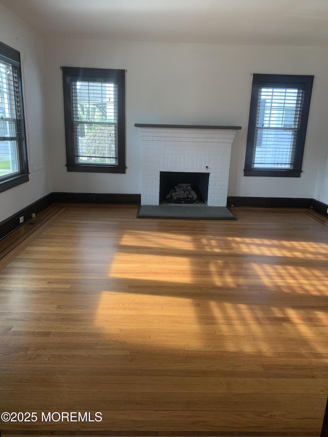 unfurnished living room with wood finished floors and a fireplace