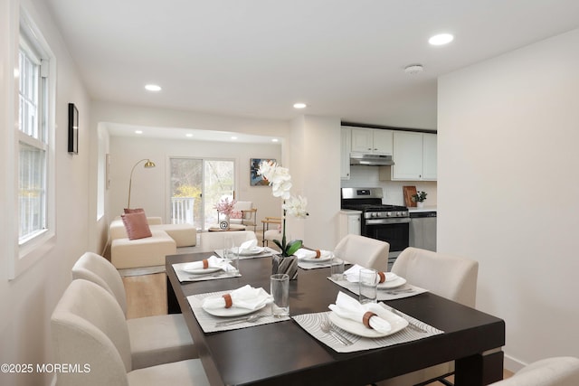 dining room featuring light wood-type flooring and recessed lighting