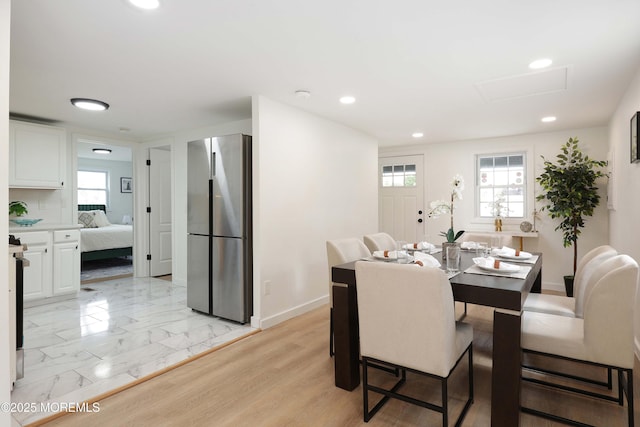 dining room featuring attic access, baseboards, and recessed lighting