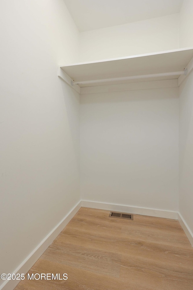 walk in closet featuring light wood finished floors and visible vents