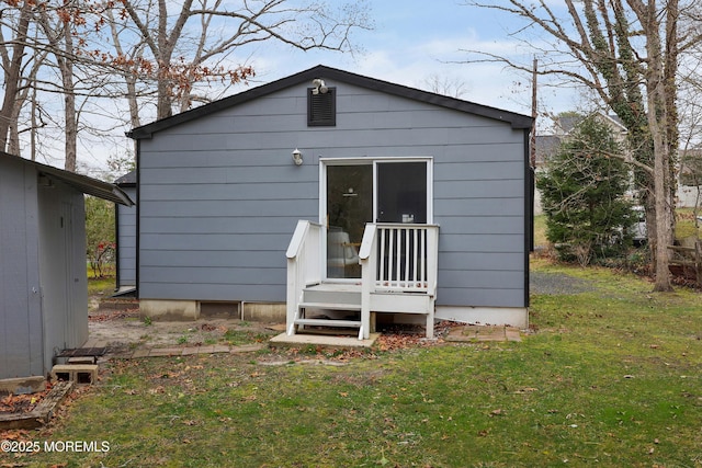 back of property featuring a yard