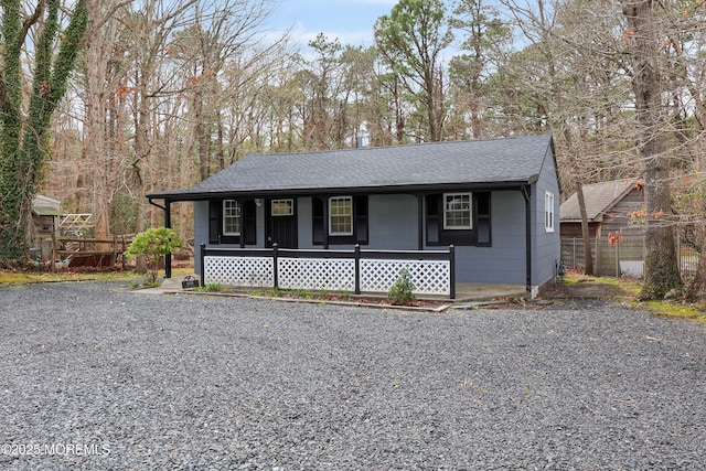 view of front of home with a porch and a shingled roof