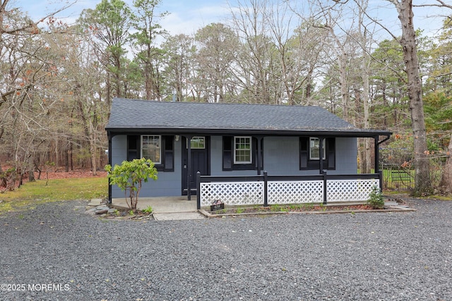 view of front of house with covered porch and roof with shingles