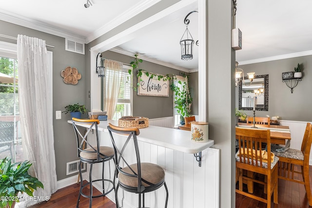 2015 Red Cedar St, Toms River, NJ 08753 - dining area with healthy amount of natural light, dark wood finished floors, ornamental molding, and a wainscoted wall