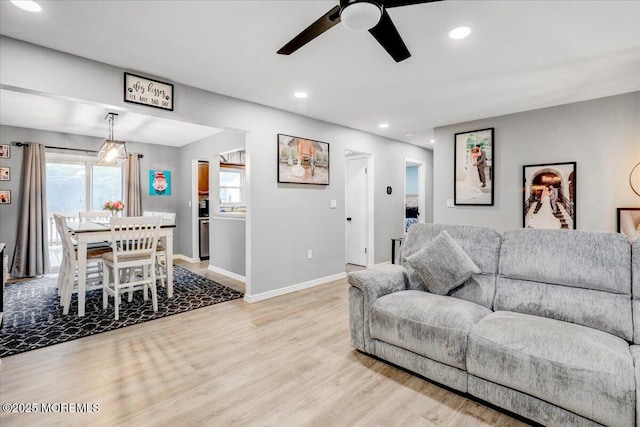 living area with light wood finished floors, baseboards, a ceiling fan, and recessed lighting