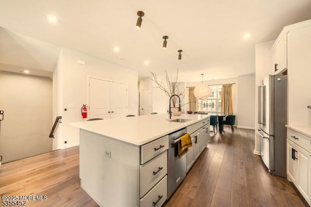 2206 Evans Ln, Middletown, NJ 07748 - kitchen featuring a sink, hardwood / wood-style floors, light countertops, a kitchen island with sink, and appliances with stainless steel finishes