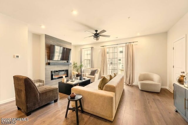 2206 Evans Ln, Middletown, NJ 07748 - living room with a large fireplace, baseboards, a ceiling fan, and wood finished floors