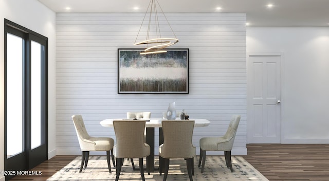dining space with an inviting chandelier, a wealth of natural light, wood finished floors, and recessed lighting