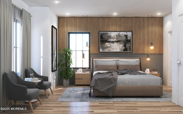 bedroom with recessed lighting and wood finished floors