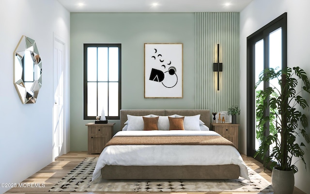 bedroom with light wood-style floors and recessed lighting