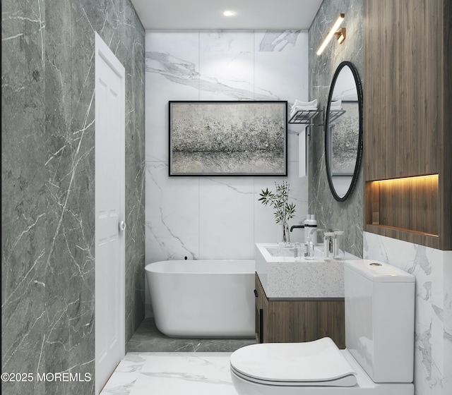 full bathroom featuring tile walls, toilet, marble finish floor, a soaking tub, and vanity