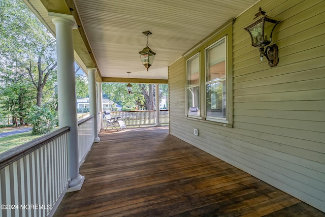 wooden terrace featuring covered porch