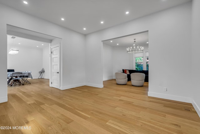 unfurnished room featuring a chandelier, recessed lighting, and light wood-style flooring