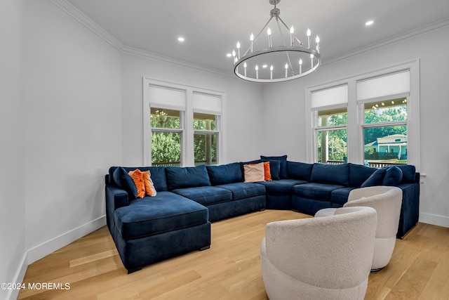 living area with baseboards, light wood finished floors, an inviting chandelier, and crown molding