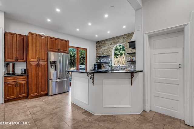 kitchen featuring brown cabinetry, stainless steel fridge with ice dispenser, open shelves, and recessed lighting