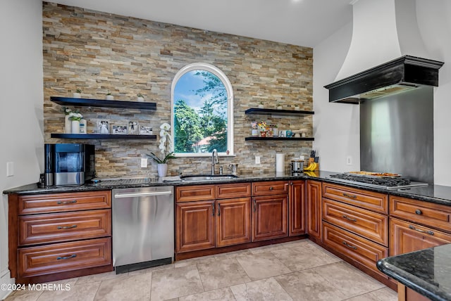 kitchen featuring dark stone countertops, open shelves, a sink, stainless steel appliances, and custom exhaust hood