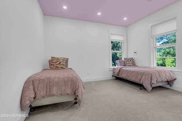 carpeted bedroom featuring baseboards and recessed lighting