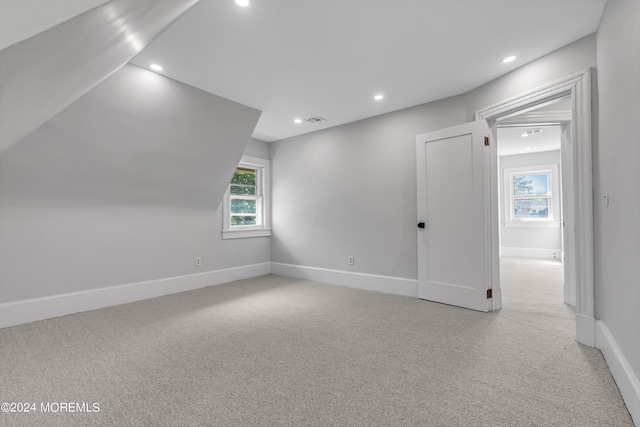 additional living space featuring carpet flooring, visible vents, a healthy amount of sunlight, and recessed lighting