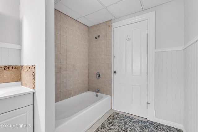 bathroom with wainscoting, tile patterned flooring, tub / shower combination, and vanity