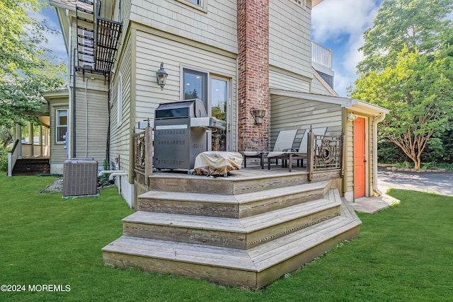 wooden deck with a yard and cooling unit