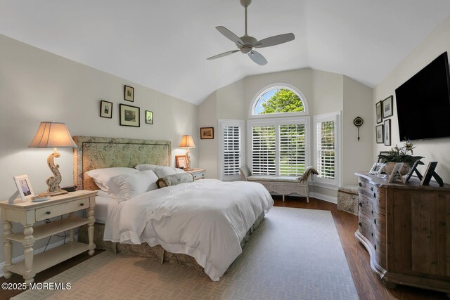 bedroom with lofted ceiling, dark wood-style floors, a ceiling fan, and baseboards