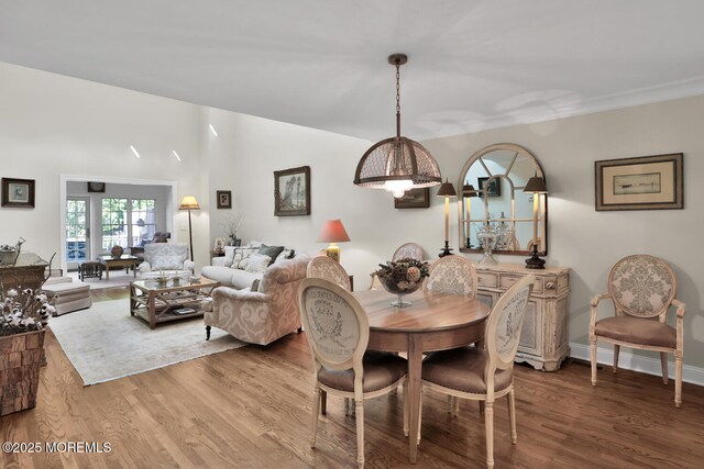 dining room featuring wood finished floors and baseboards