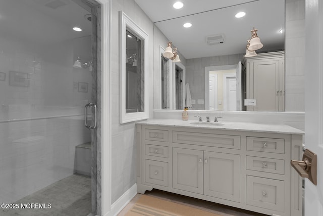 full bath featuring a stall shower, vanity, and recessed lighting