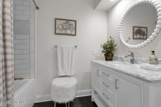 bathroom featuring baseboards, tile patterned flooring, vanity, and shower / bath combination with curtain