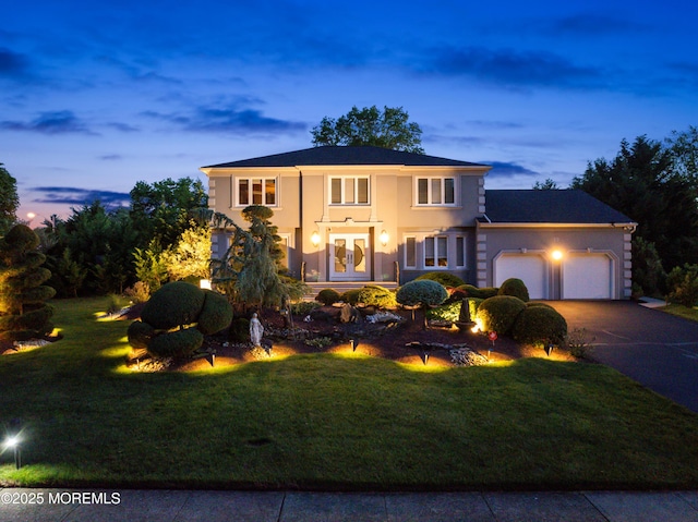 19 Dartmoor Dr, Manalapan, NJ 07726 - mediterranean / spanish house with french doors, a garage, a front yard, concrete driveway, and stucco siding