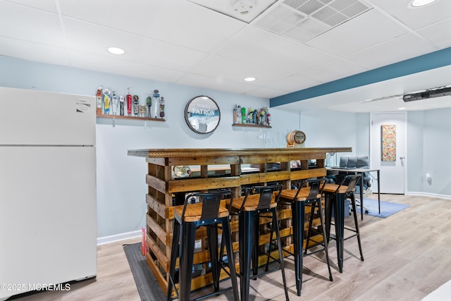 19 Dartmoor Dr, Manalapan, NJ 07726 - indoor dry bar featuring freestanding refrigerator, wood finished floors, baseboards, a drop ceiling, and recessed lighting