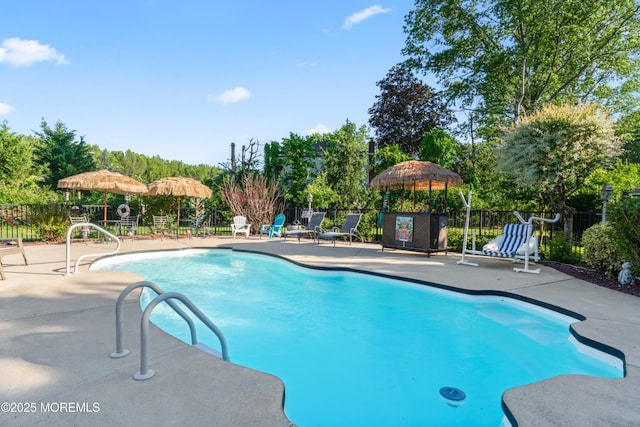 19 Dartmoor Dr, Manalapan, NJ 07726 - community pool featuring a patio and view of scattered trees