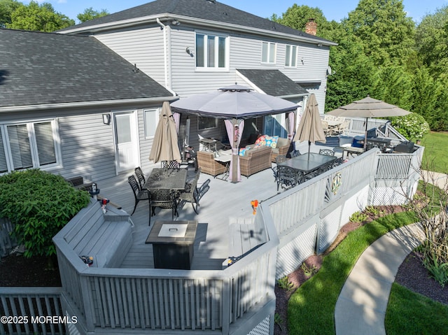 19 Dartmoor Dr, Manalapan, NJ 07726 - back of house with an outdoor living space with a fire pit, outdoor dining area, a wooden deck, a gazebo, and roof with shingles